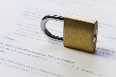 A padlock on Java program code. Symbol of software / application and computer security. High key photo. Can be used as background.